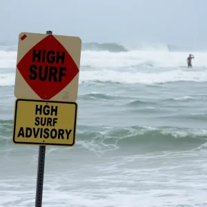 Waves crashing on a beach under high surf advisory warning